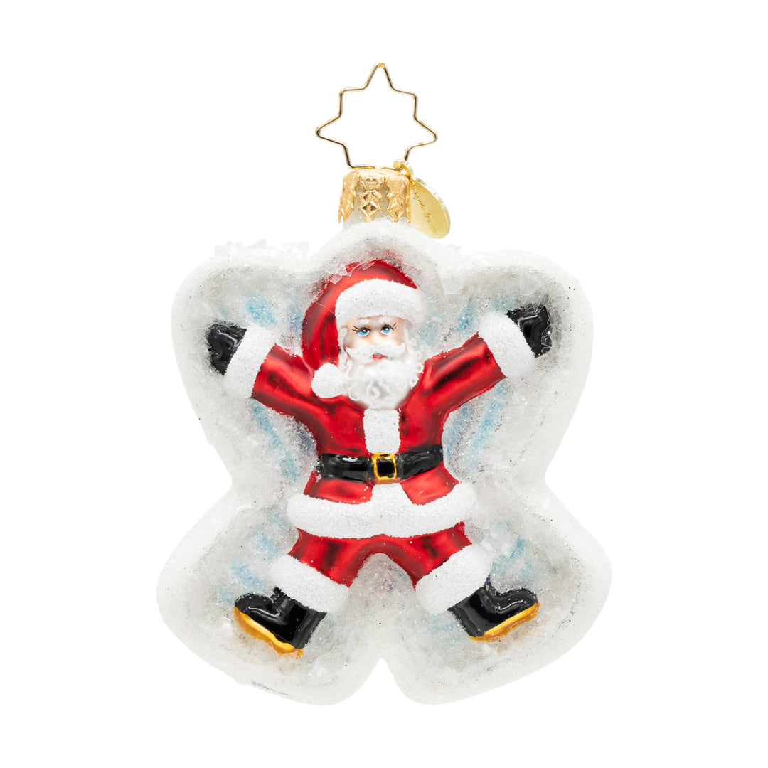 Glass Christmas ornament of Santa Claus making a snow angel in white glittery snow.