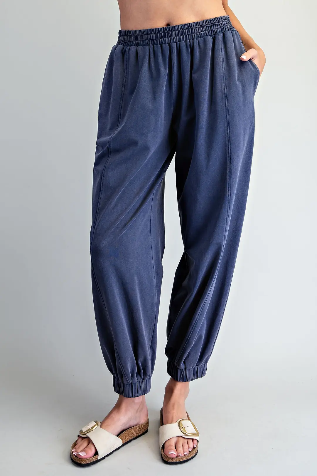 Odette solid blue joggers with elastic waist, side pockets, and vertical panel seams.