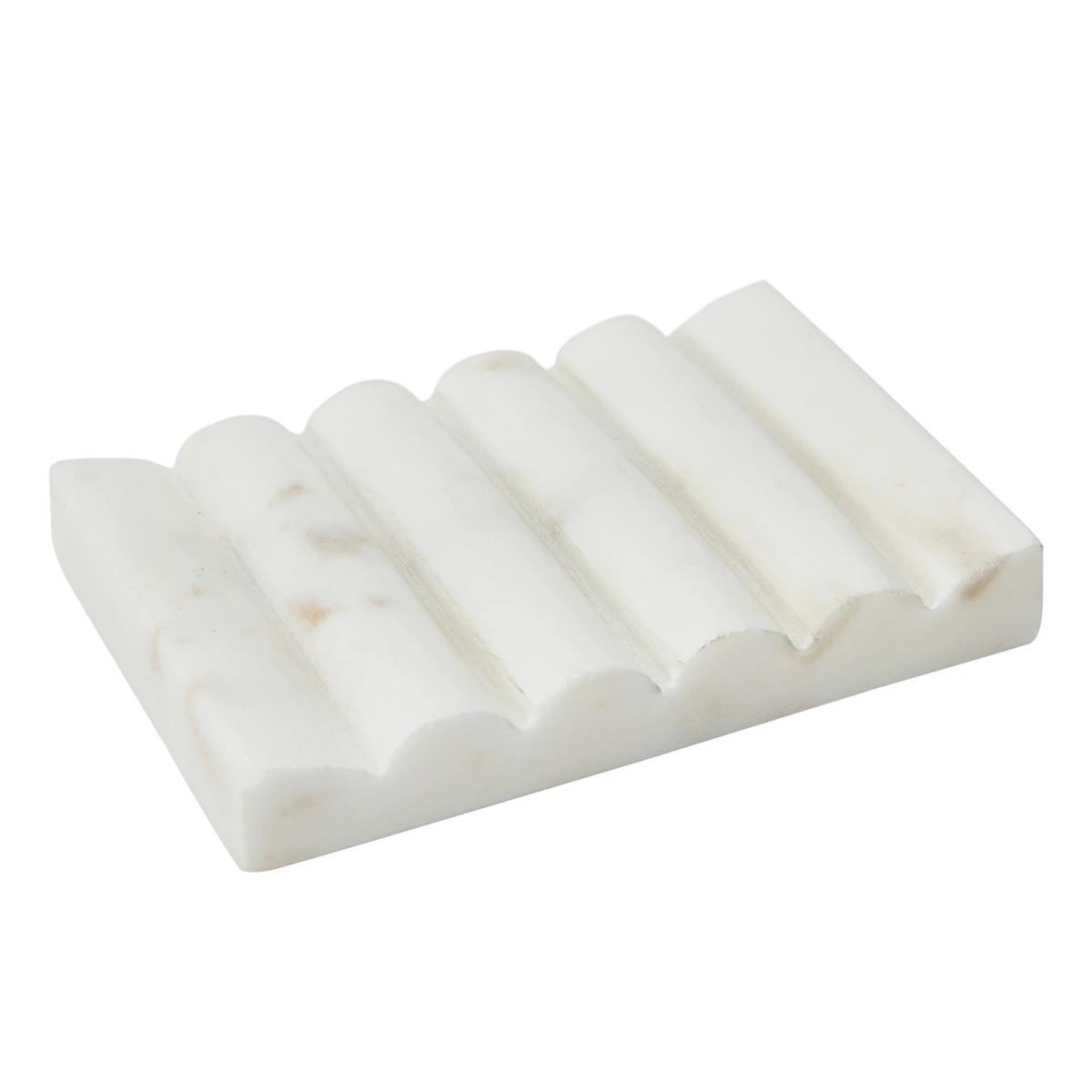 White carved marble soap dish with a grooved, wavy design for drainage.