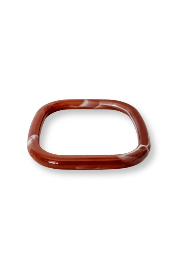 WS Aria Bangle in a square shape with a reddish-brown and white marbled resin finish.