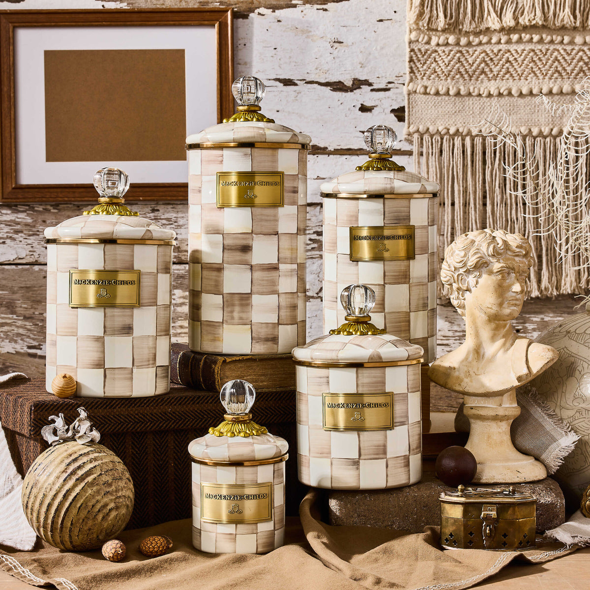 Hand-glazed steel canister with mocha checkered pattern, bronzed stainless rim, brass accents, and glass lid.