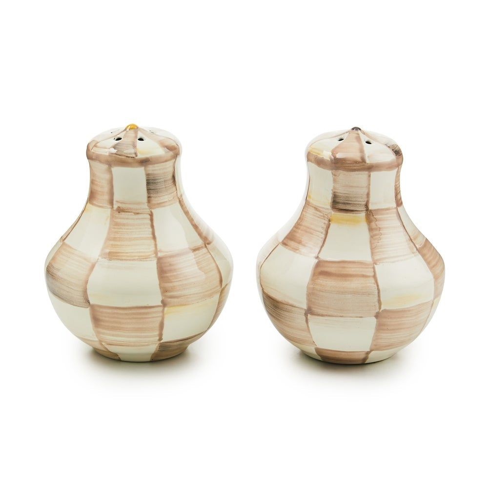 Hand-glazed steel salt and pepper shakers with mocha check pattern on heavy-gauge bodies.