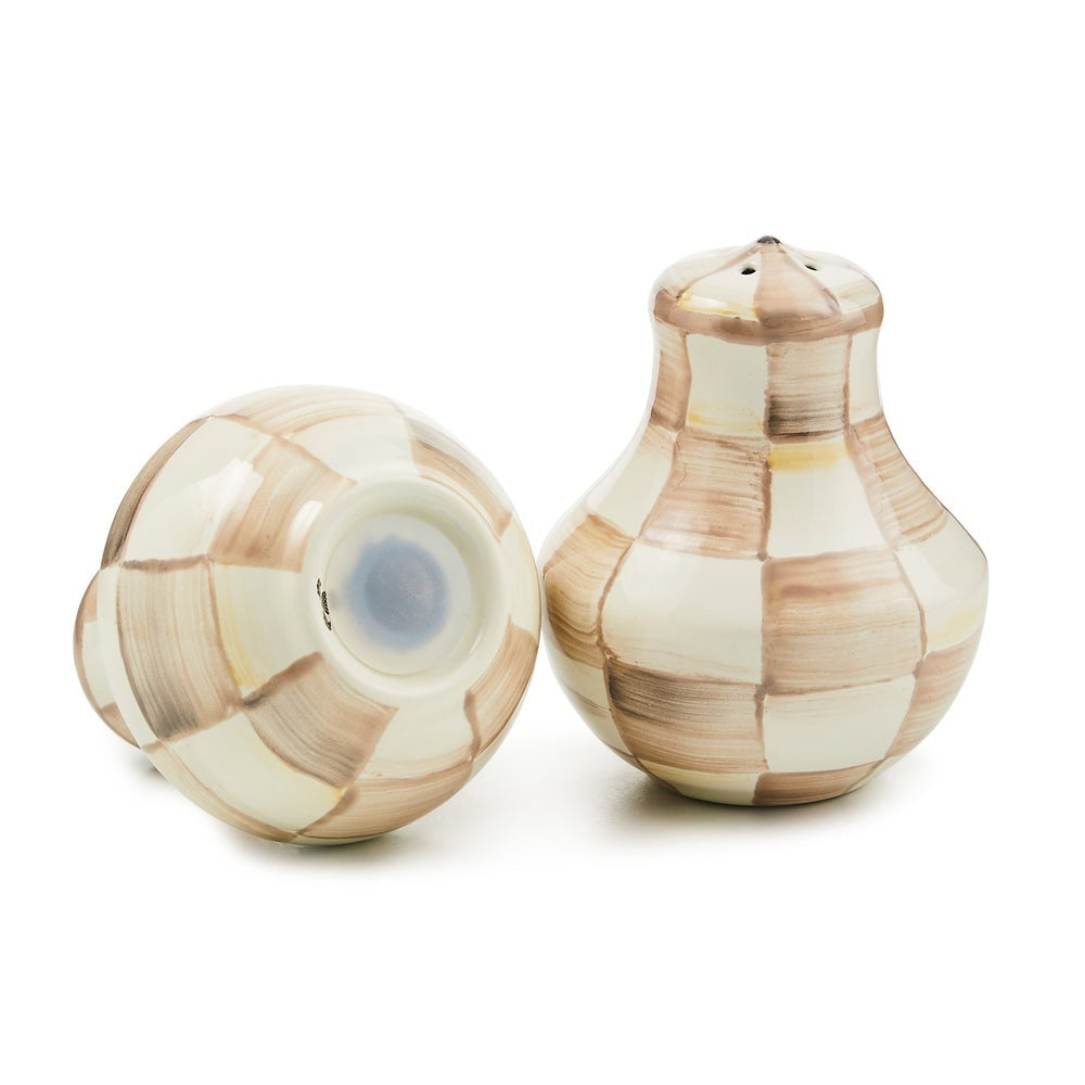 Hand-glazed steel salt and pepper shakers with a mocha check pattern.