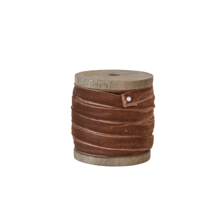 10 yards of brown velvet ribbon wrapped around a rustic mango wood spool.
