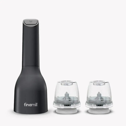 Black FinaMill electric spice grinder with two attached grinding pods on a neutral background.