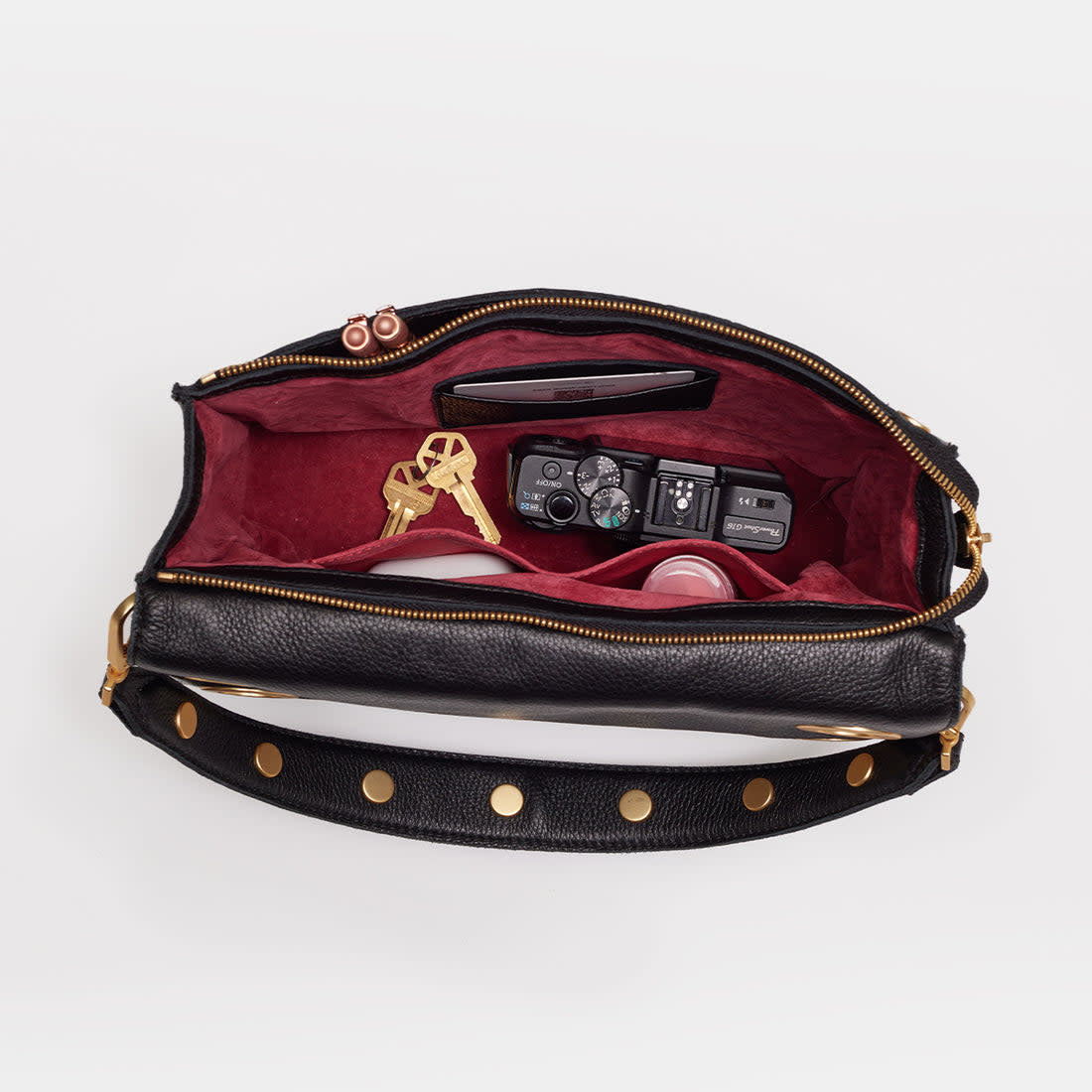 Black brushed gold Montana Clutch with vintage Hammitt strap, grommets, and magnetic closure.