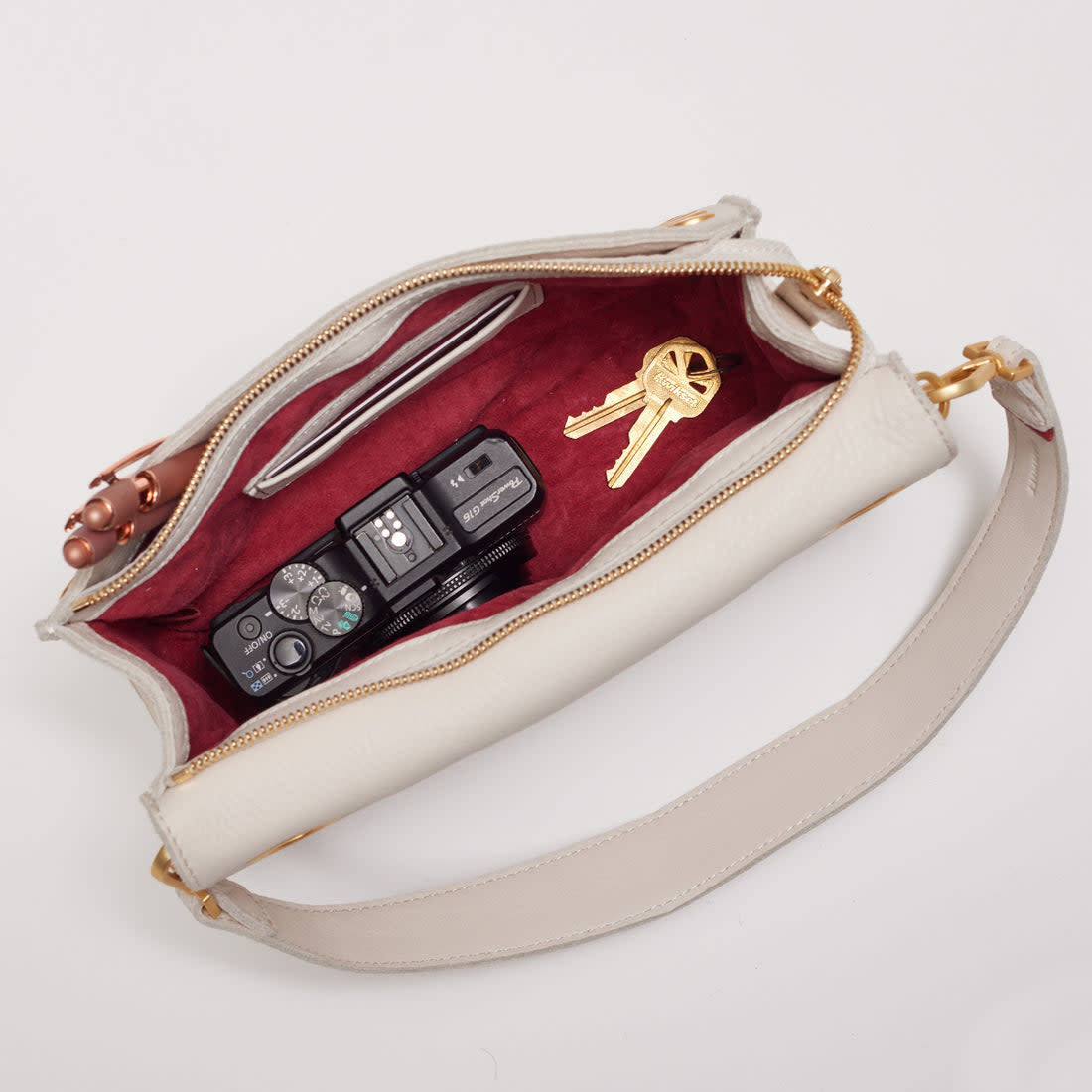 White brushed gold Montana Clutch Large with vintage Hammitt strap, grommets, and magnetic closure.
