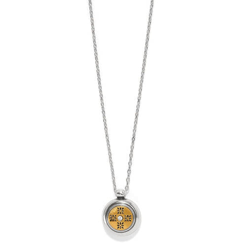 Mini round pendant necklace in silver and gold tones with a crystal center.