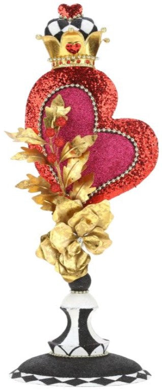 A decorative finial featuring a red glitter heart with a crown, gold leaves, and a black and white checkered base.
