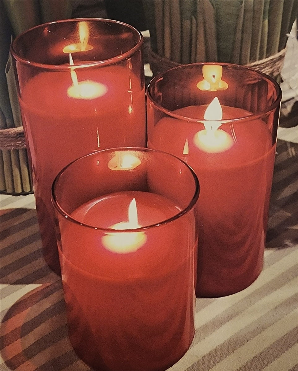 Glass pillar candle with realistic moving flame effect on warm white LED lights.