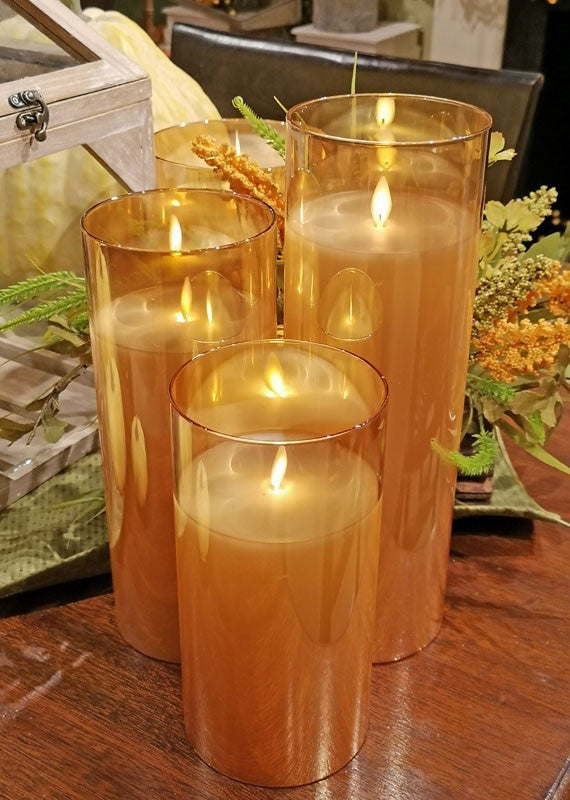 Glass pillar candle with realistic moving flame effect in warm white light