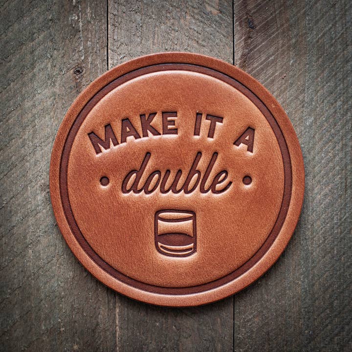 Square leather coaster in rich brown with visible grain texture