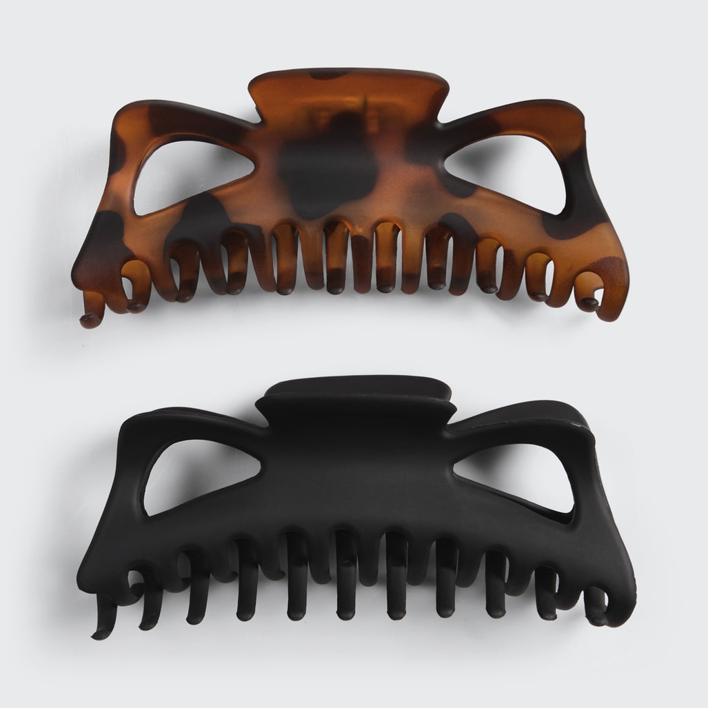Two recycled plastic jumbo classic claw hair clips in tortoiseshell and matte black.