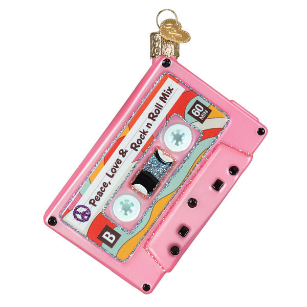 Pink cassette tape Christmas ornament with 'Peace, Love & Rock n Roll Mix' label and glitter trim.