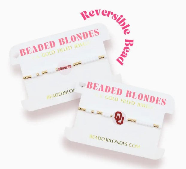 Two gold and white beaded stretch bracelets featuring a reversible OU logo and Sooners text bead.