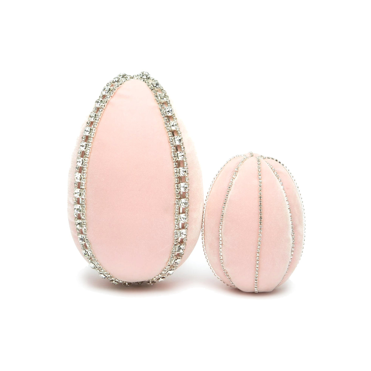 Two pink velvet eggs decorated with rhinestones, one tall and one round.