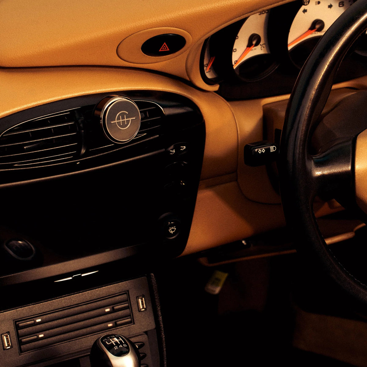 Lost in Amalfi Car Diffuser with a silver scent disk mounted on a car's air vent.