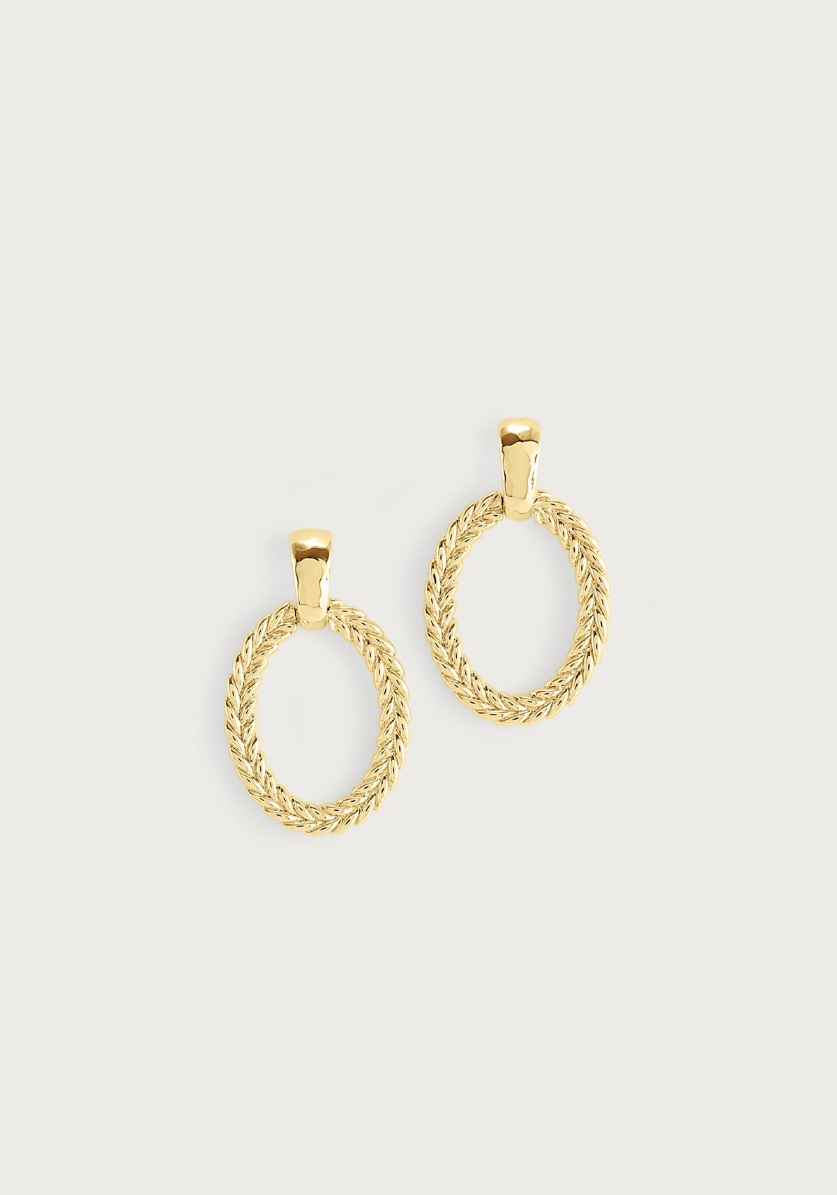 Gold Cheval Ring Earrings featuring an oval braided texture hanging from a smooth gold stud.