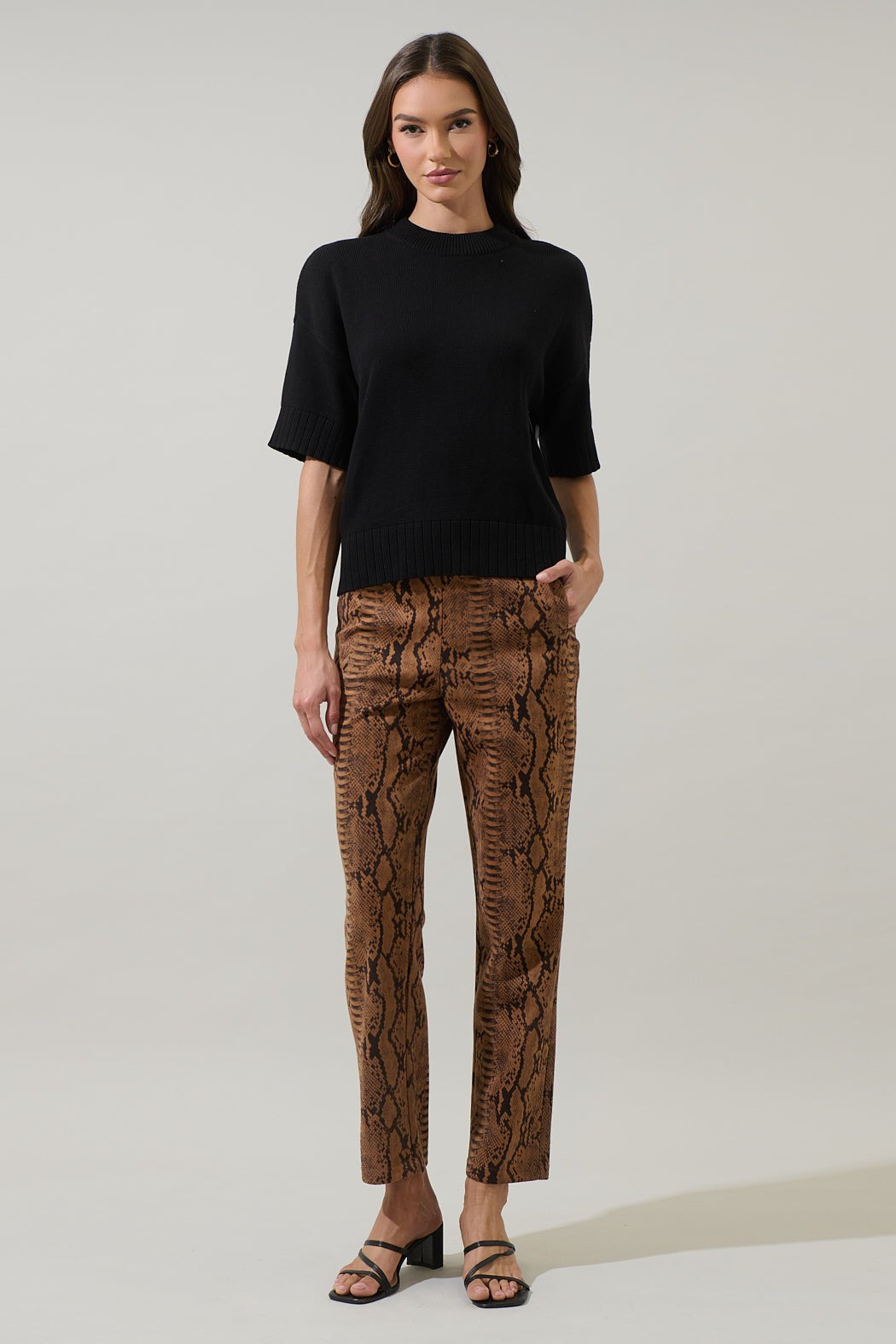 Relaxed fit drop shoulder sweater top in off-white with ribbed cuffs.