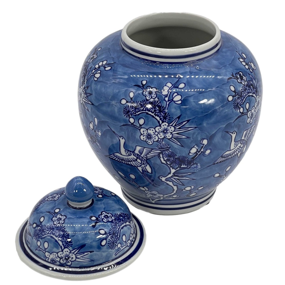 10-inch blue and white ceramic ginger jar with floral and crane chinoiserie design and matching lid.