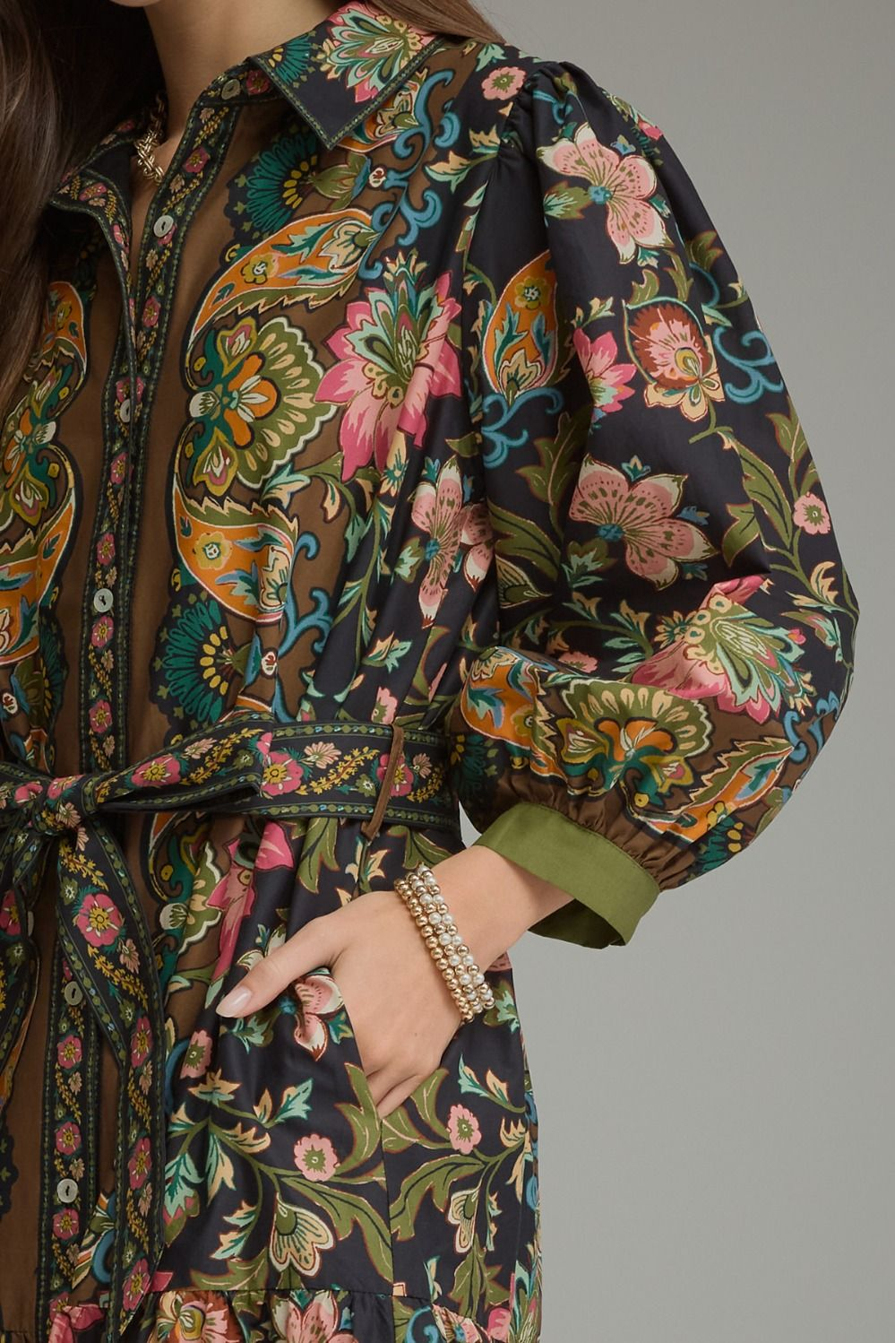 Close-up of the Chloe midi dress featuring a floral paisley print, balloon sleeves, and waist tie.