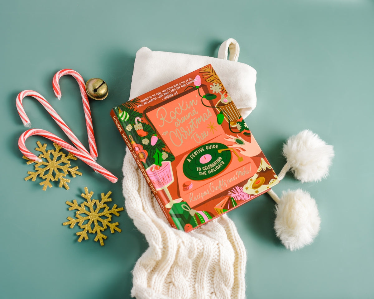 Rockin' Around the Christmas Tree book with candy canes, snowflakes, and a knitted scarf.