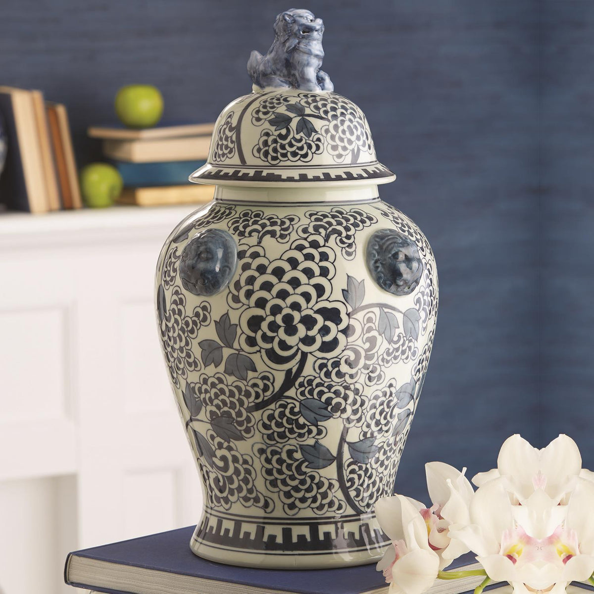 Blue and white porcelain temple jar with hand-painted peony flowers and a foo dog lid finial.
