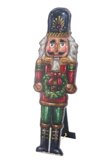 Red wooden Christmas nutcracker porch leaner with black hat and gold accents.
