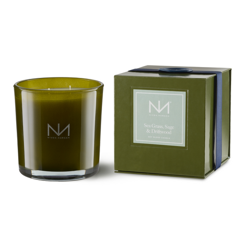 Dark olive glass jar containing a double-wick soy blend candle with an even burn.