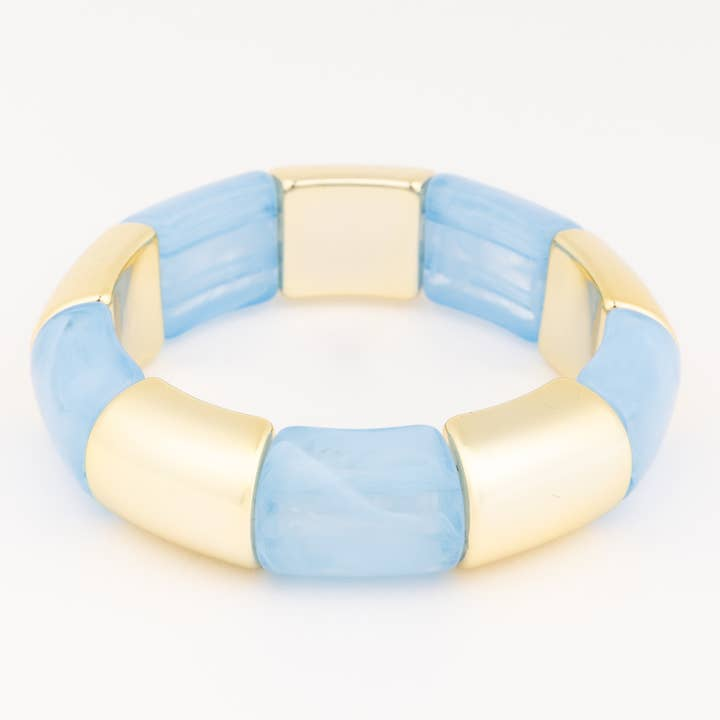 Audrey Blue Bracelet featuring alternating light blue marbled and polished gold-tone curved beads.