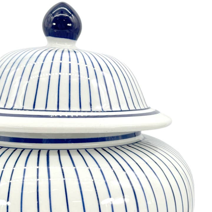 Close-up of a 15.5-inch wide ceramic ginger jar with vertical blue and white stripes and a lid.