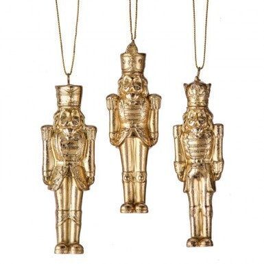 Three 4-inch resin gilded nutcracker ornaments in various soldier poses with gold hanging strings.
