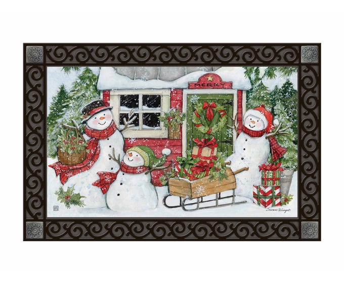 MatMate doormat with three snowmen, a red cabin, and gifts, featuring a decorative border.