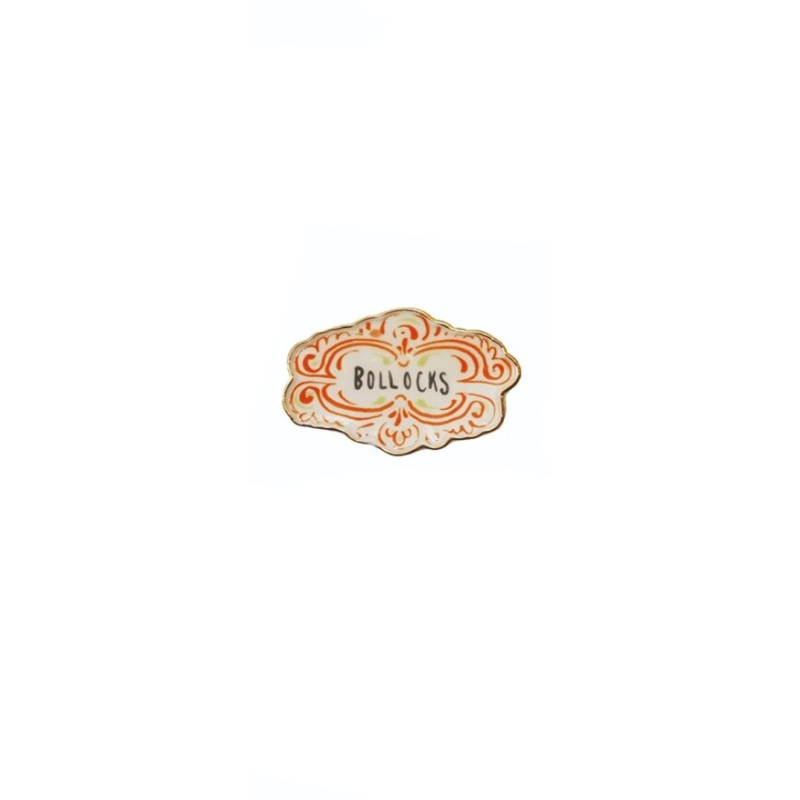 Decorative stoneware magnet with orange scrollwork and the word BOLLOCKS in the center.