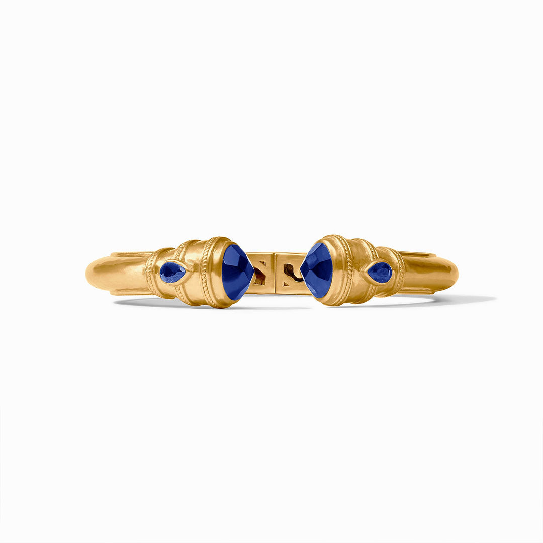 Cannes Demi Cuff in gold with blue gemstone endcaps and pear-shaped sapphire accents.