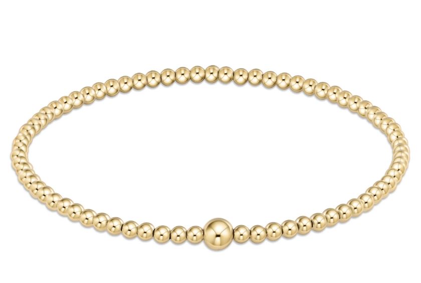Classic gold-colored bangle bracelet with a smooth cylindrical shape.