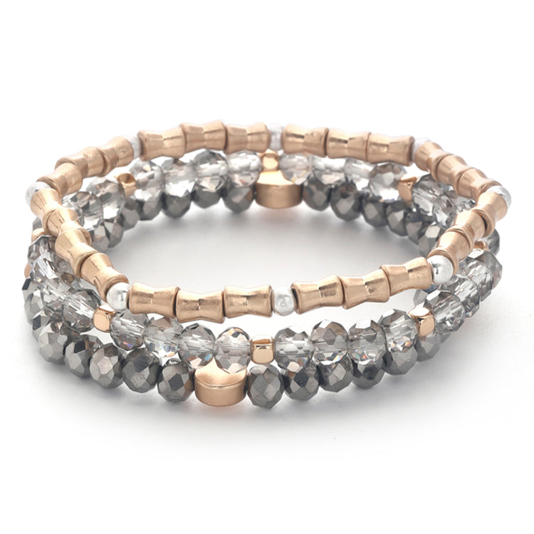 Set of three stretch bracelets with rose gold, silver, and faceted grey glass beads.