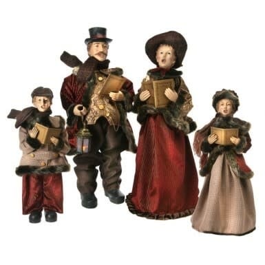 Fabric caroller family set featuring four standing figures in festive attire with red hats.