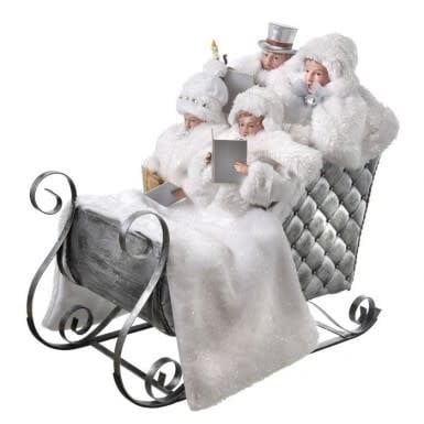White frosted faux fur sleigh caroller with wood frame and black silver metal rudders