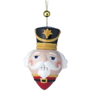 Red resin nutcracker head ornament with white beard and black uniform standing on a base.