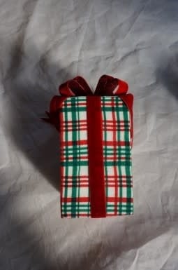 9-inch red plaid ornament with a white bow on a tree branch