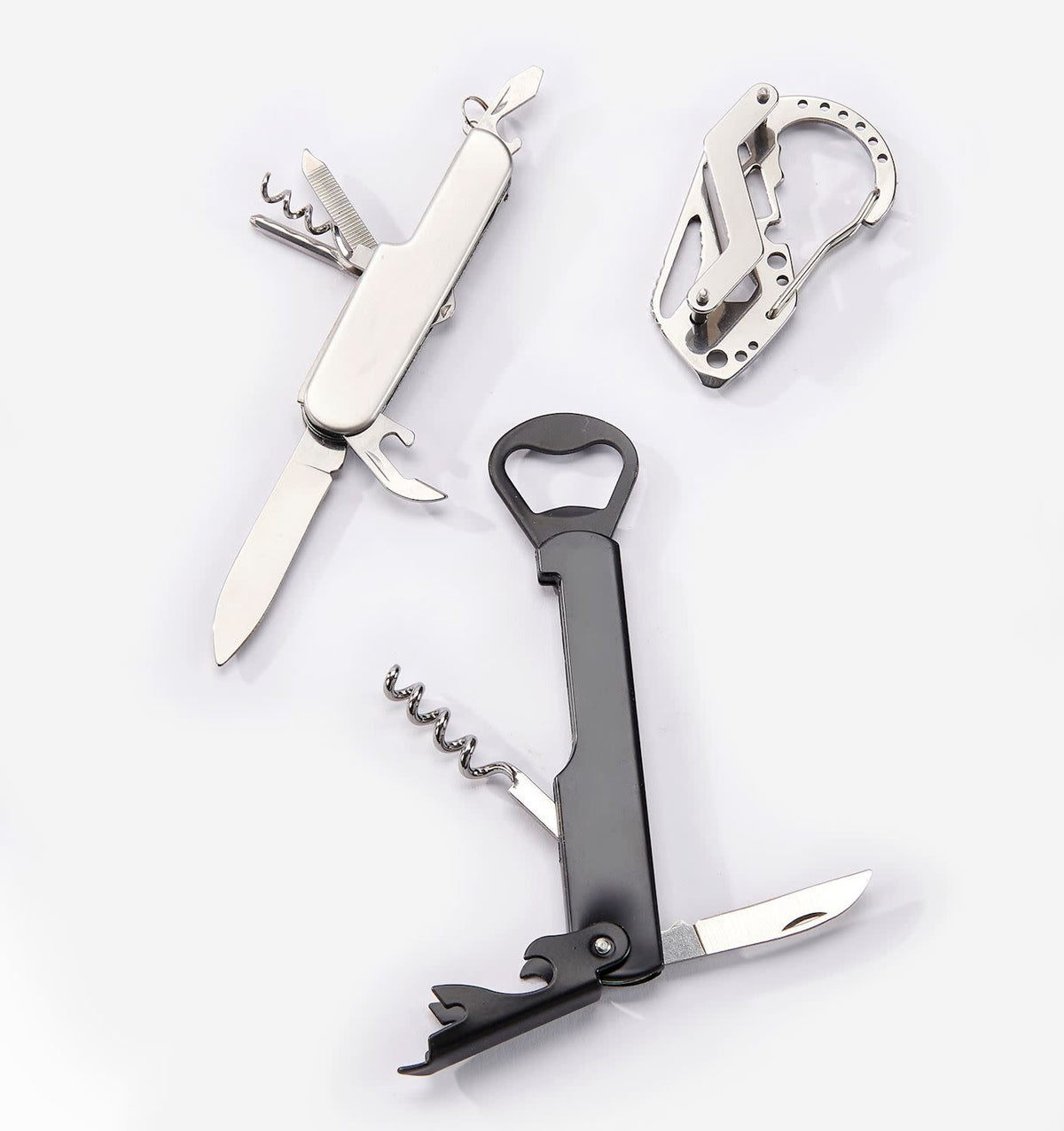 Stainless steel multi-function pocket tool with multiple utility functions in a compact rectangular case.