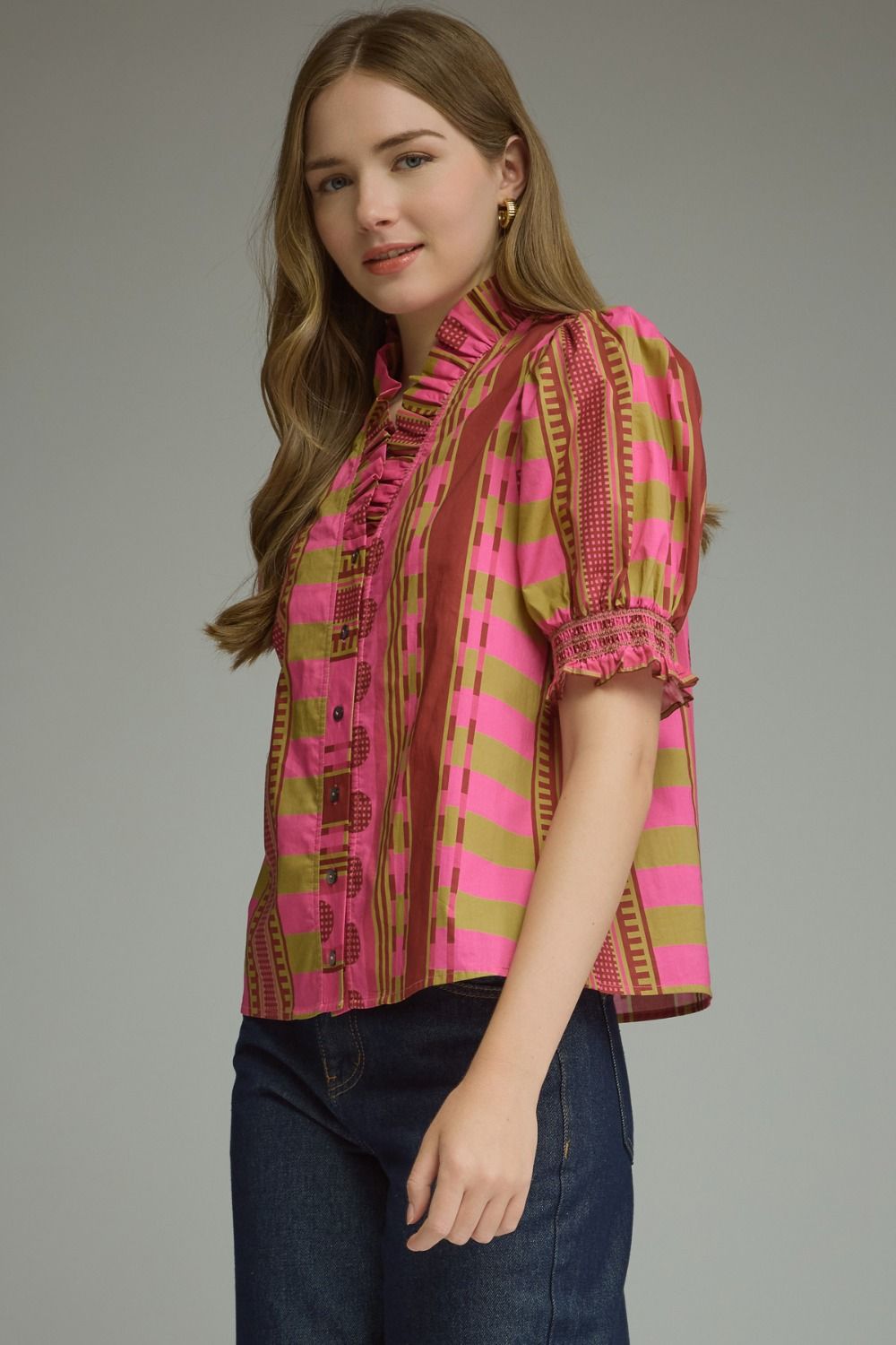 Woman wearing the Athena Mixed Print Short Puff Sleeve Top with pink and olive stripes.