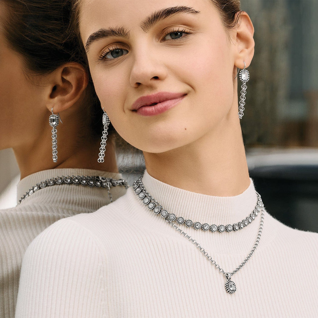 Woman wearing the Twinkle Luxe silver plated necklace with fine quality crystals.