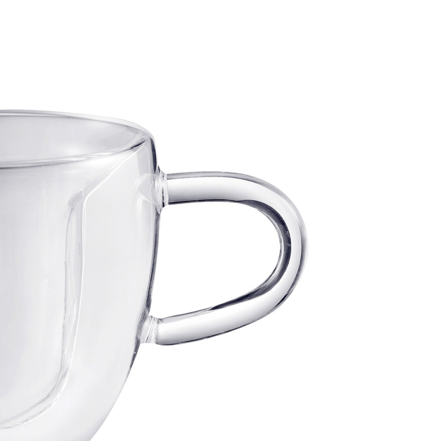 Close-up of the handle and double-walled glass on a heart-shaped espresso cup.