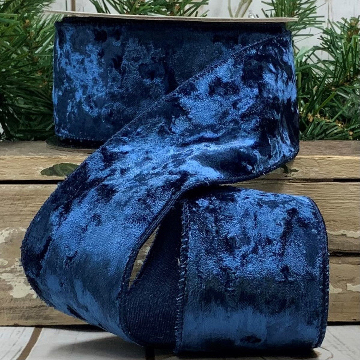 2.5 inch wide navy blue crushed velvet ribbon on a spool with a textured finish.