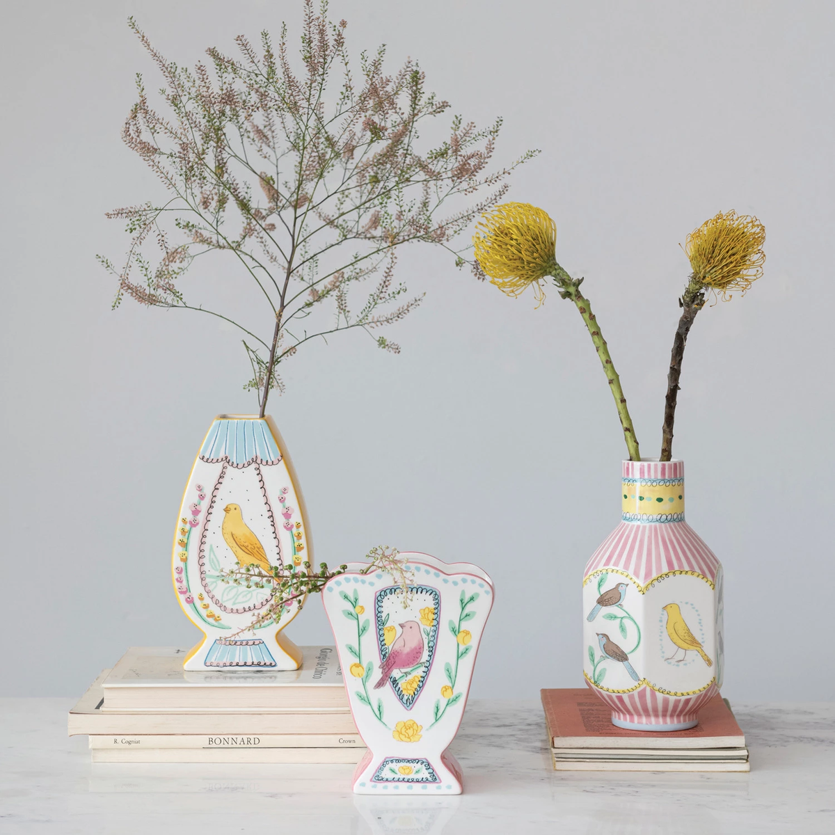 Tall dolomite ceramic vase featuring a bird motif in neutral tones with an organic silhouette.
