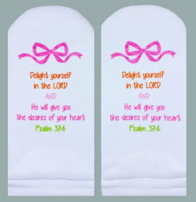 White socks featuring a pink bow and the Bible verse Psalm 37:4 in colorful text.