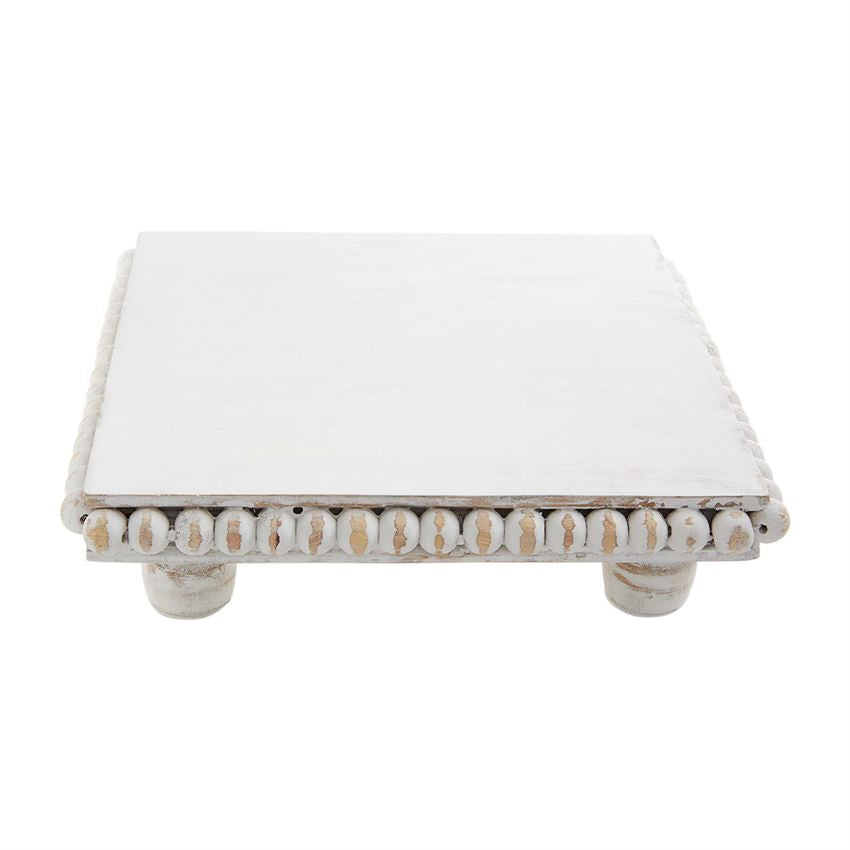 Square white beaded trivet made from mango wood with an 8-inch diameter.
