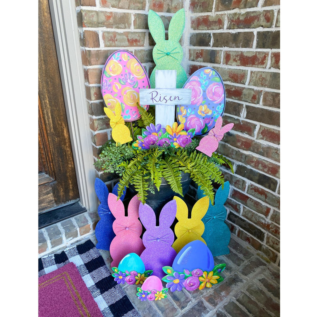 Artful Risen Cross & Flowers metal garden stake with cross silhouette surrounded by floral patterns in earth tones.